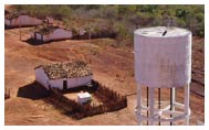 Water tower near small group of buildings