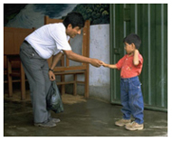 Fermin Tenorio shakes hands with Dr. Roger Zapata