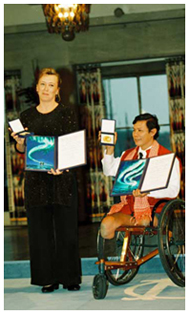 Jody Willams and Tun Channereth display their Nobel medals and plaques