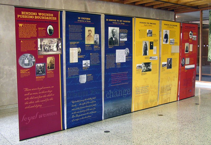 The six banners installed in a display configuration of Binding Wounds, Pushing Boundaries