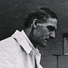 Photograph of Arthur Keith (1866-1955), with skulls on his work table. Image B016102 in the Images from the History of Medicine (IHM) collection.