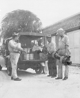 A fumigating and disinfecting team is unloading materials and equipment from the back of a truck in New Orleans.