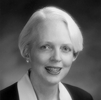 Dr. Selma Harrison Calmes, a White female with short hair in a collared jacket posing for her portrait.