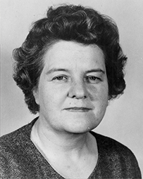 Dr. Helen Aird Dickie, a female with short hair posing for her portrait.