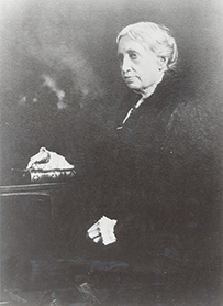 Dr. Sarah Read Adamson Dolley, a nineteenth century portrait of a female posing at a desk with a book.