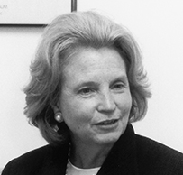 Dr. Kathleen M. Foley, a White female in a dark suit sitting on a couch.