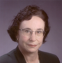 Dr. Florence Pat Haseltine, a White female wearing a dark jacket posing for her portrait.