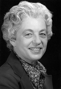 Dr. Elizabeth Dexter Hay, a White female with short curly hair posing for her portrait. 