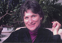 Dr. Mary Catherine Raugust Howell, a White female with short hair seated outdoors posing for a portrait.