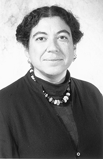 Dr. Perri Klass, a female wearing a sweater and beaded necklace posing for her portrait.