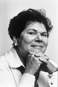 Dr. Lila Stein Kroser, a White female posing for a portrait with her hands folded under her chin.