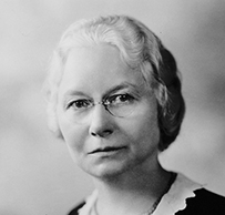 Dr. Esther Clayson Pohl Lovejoy, a White female in a dark dress posing for her portrait.