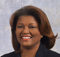 Dr. Shirley F. Marks, a smiling African American female in suit and pearls posing for her portrait.