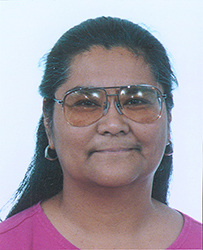 Dr. Barbara L. Riley, an American Indian female wearing glasses and a pink top smiling for her portrait.