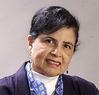 Dr. Merlyn Meneze Rodrigues, a female in a blue jacket with a scarf posing for her photo.