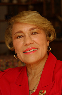 Dr. Omega C. Logan Silva, a White female in a red jacket smiling for her portrait.