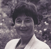 Dr. Judith Lea Swain, a White female with short hair posing outdoors for her portrait.