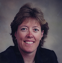 Dr. Leigh Ann Curl, a smiling White female posing for her portrait.