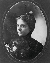 Dr. Minnie Frances Hayden Howard, a White female posing holding flowers posing for her portrait.