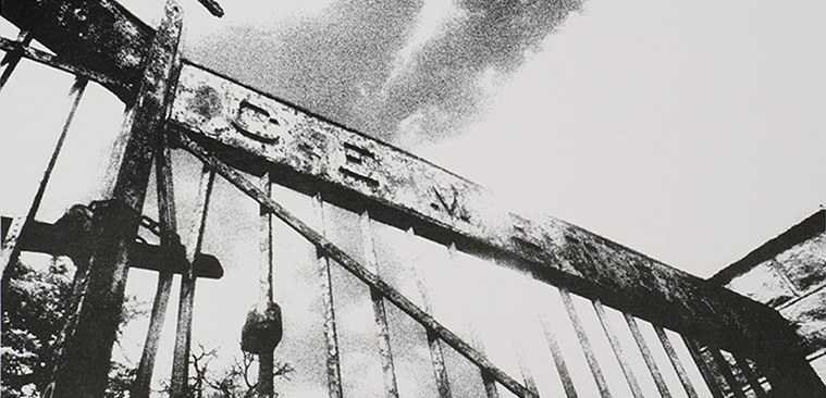 Black and white photograph of front iron gates with “Cemetery” above gates.   