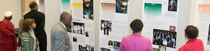 people viewing installed traveling exhibition banners.